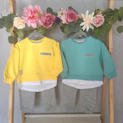 Bright and colourful boys jogger set in yellow or green with a layered look to the top and cosy grey joggers to match.